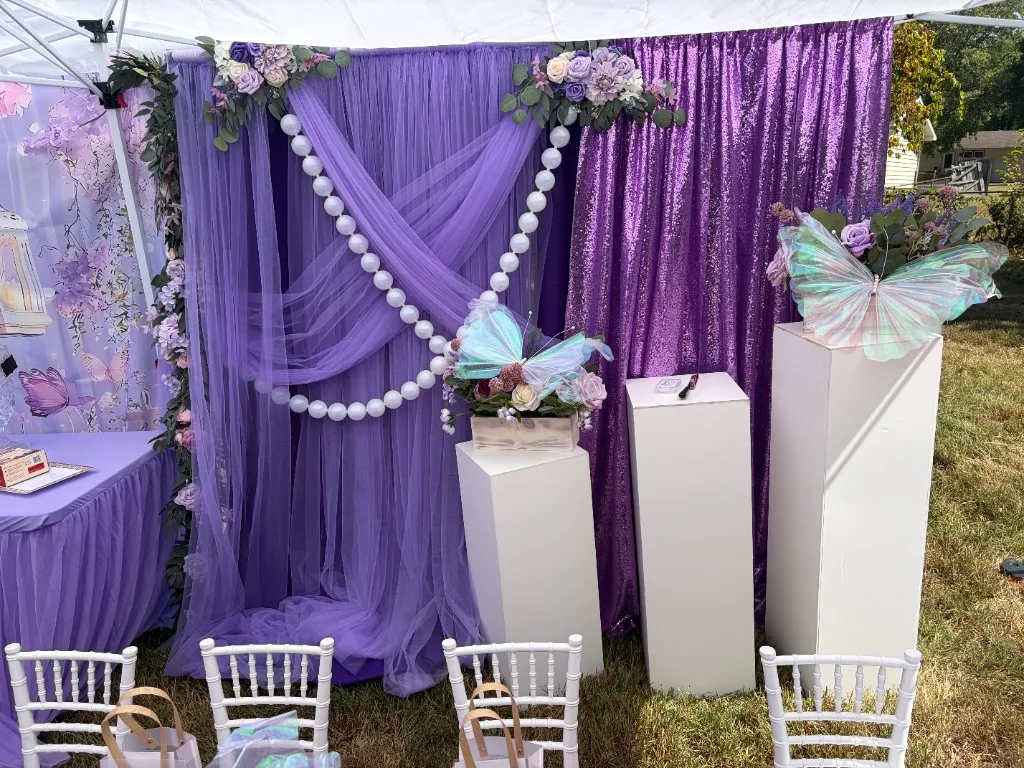 Lavender tulle and purple sequin focal point with iridescent butterflies on white pedestals