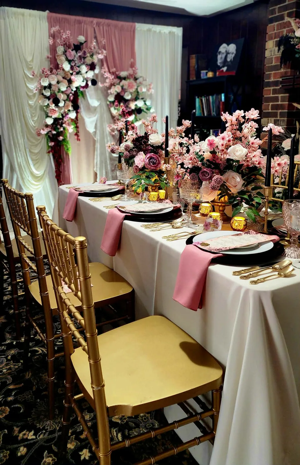 Full tablescape with gold Chiavari chairs, ivory linens, and abundant garden florals